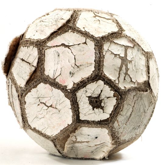White paneled football (soccer) with paint cracked and peeling off.
